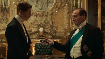 Ralph Fiennes holding out a gun in The King's Man