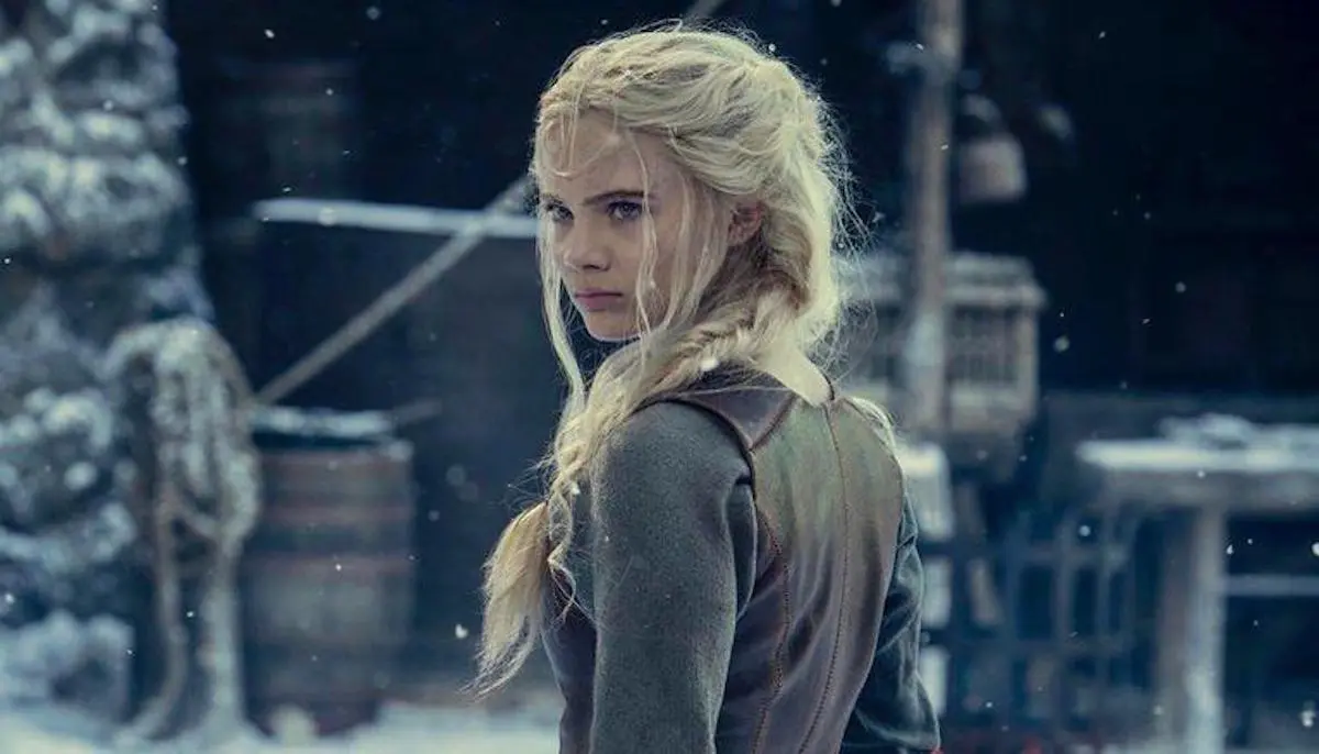 Actress Freya Allan poses in the snow as Ciri in season two of The Witcher