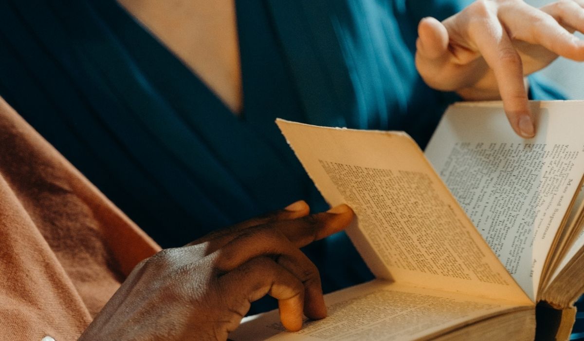 Two people looking at a book closely. (Image: Cottonbro via Pexels.) https://www.pexels.com/photo/couple-holding-a-book-6263956/