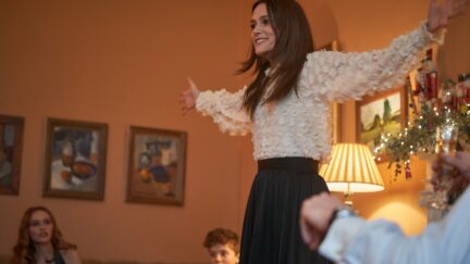 Keira Knightley with her arms raised in Silent Night