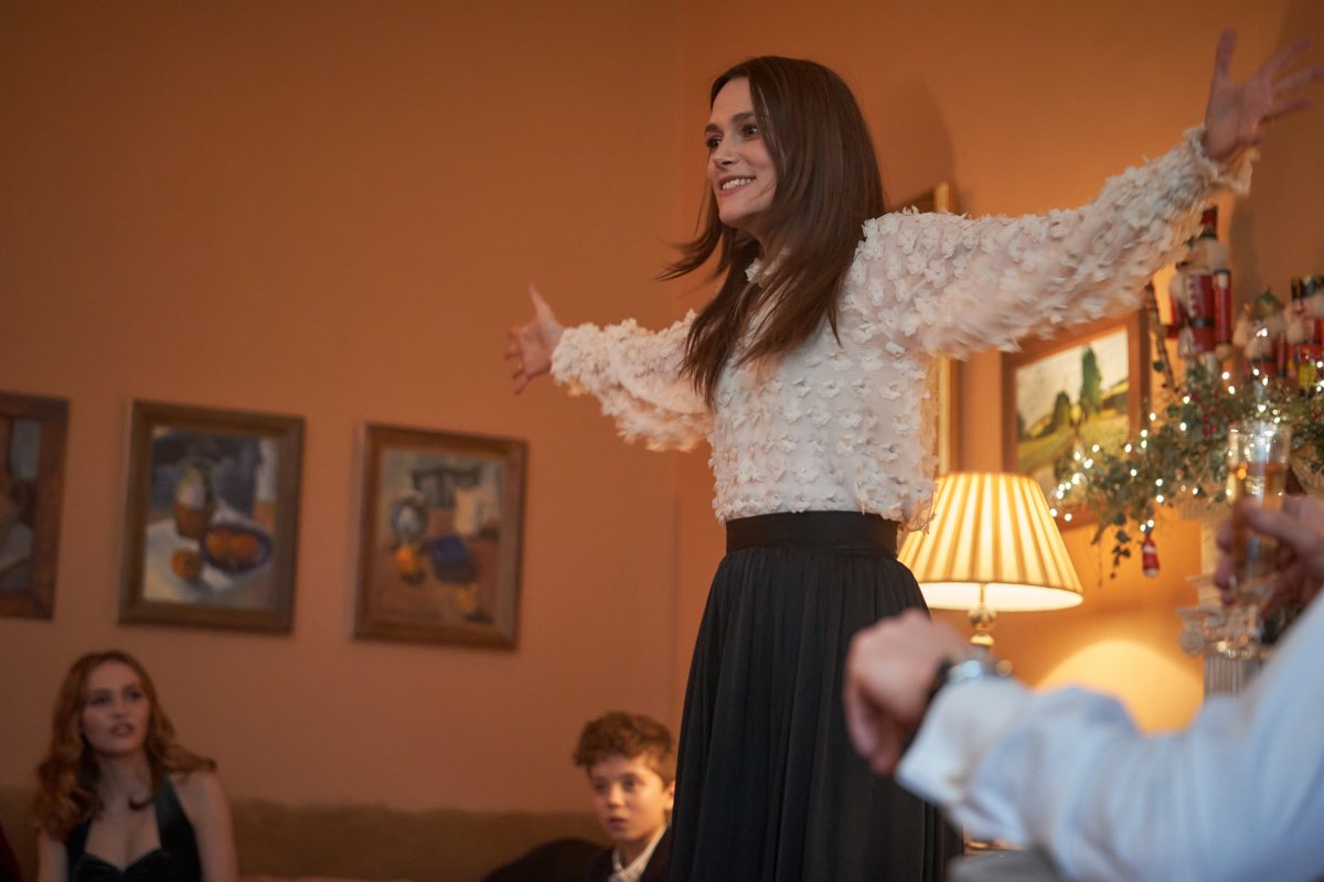 Keira Knightley with her arms raised in Silent Night
