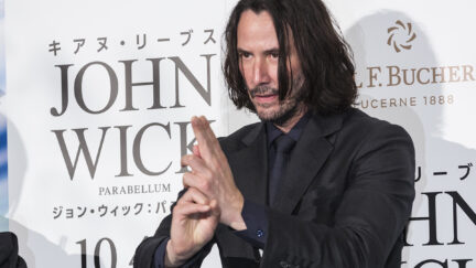 Keanu Reeves posing at a premiere