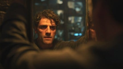 Oscar Isaac, playing Marc Spector, looks into the mirror in Moon Knight. Image via Disney.