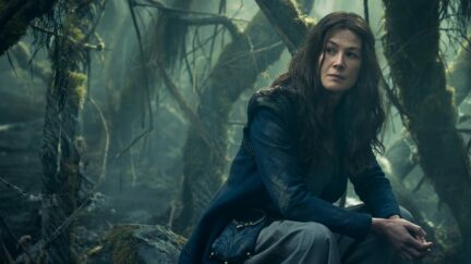 Moiraine sits in the woods in Amazon's Wheel of Time.