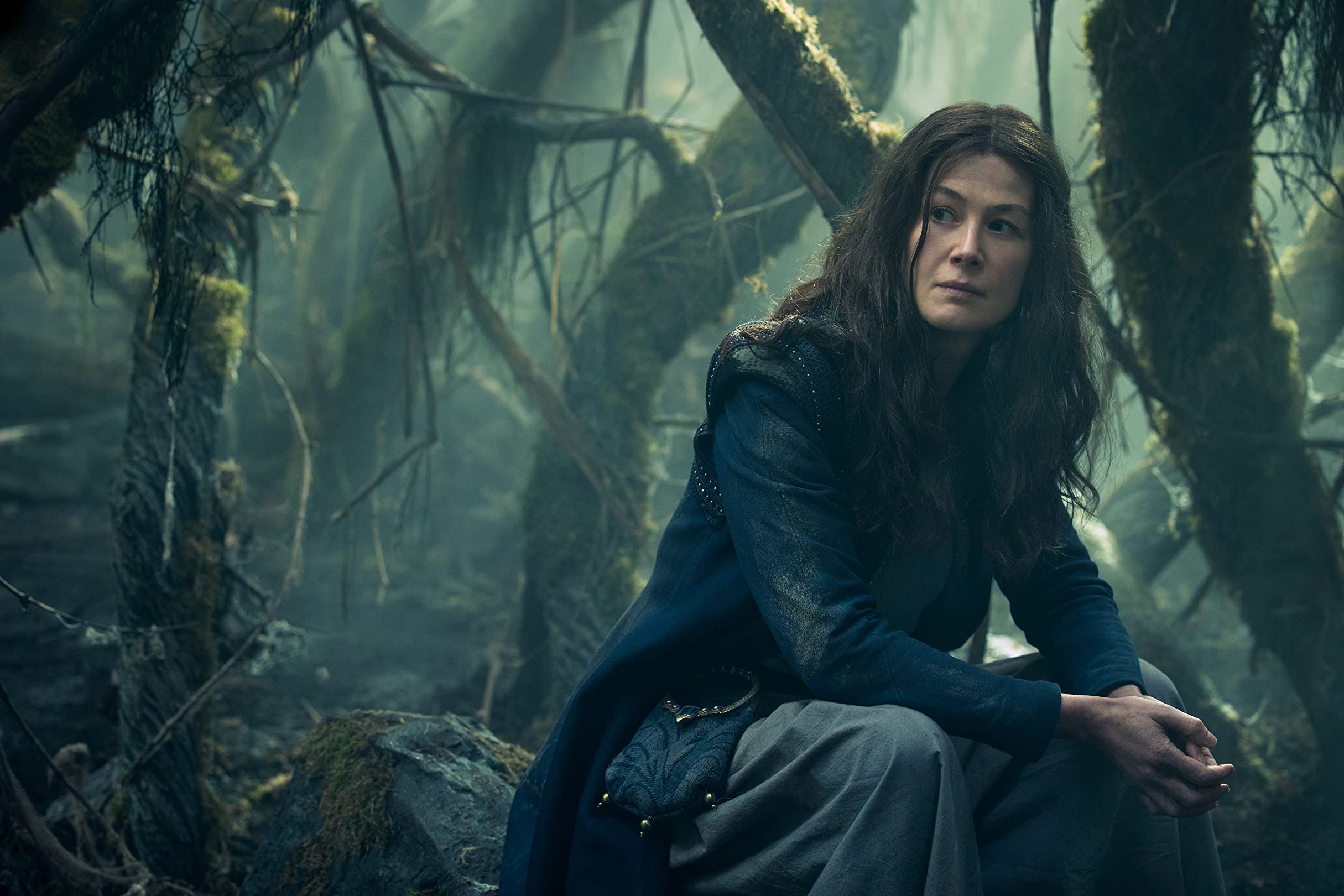 Moiraine sits in the woods in Amazon's Wheel of Time.