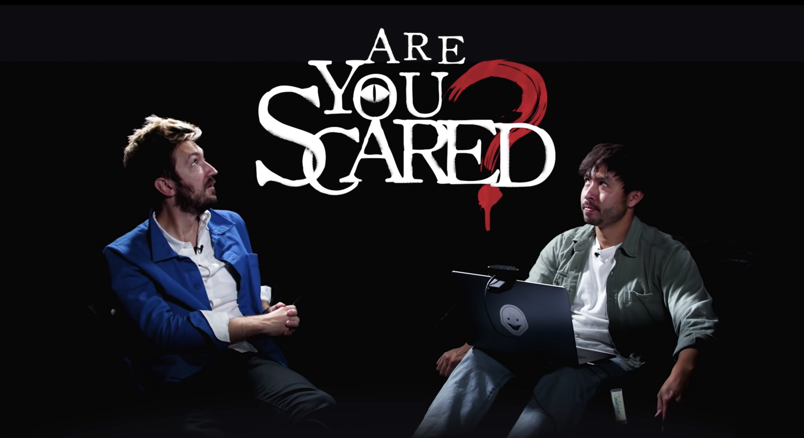 Ryan Bergara and Shane Madej staring at the "Are You Scared" sign