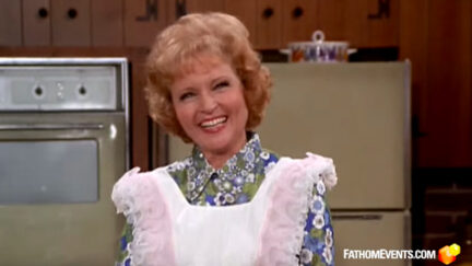 A young Betty White wears an apron and smiles at the camera during a scene from the Mary Tyler Moore Show