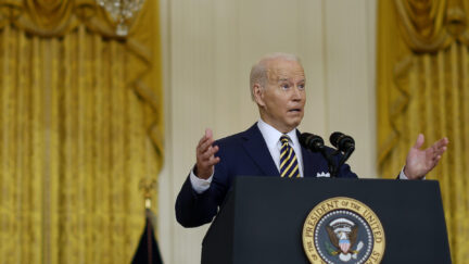Joe Biden gestures and looks surprised while giving a speech from a podium.
