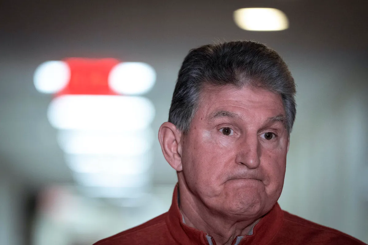 Joe Manchin gives a "welp" face, with tight lips and a far stare