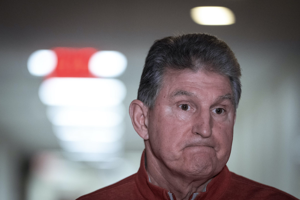 Joe Manchin gives a "welp" face, with tight lips and a far stare