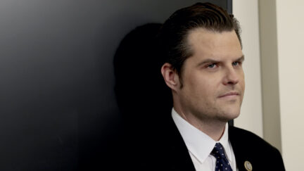 Matt Gaetz stands against a black wall