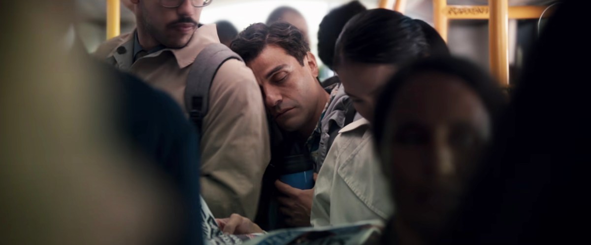 Oscar Isaac as Marc Spector/Steven Grant sleeping on the shoulder of a stranger in Moon Knight