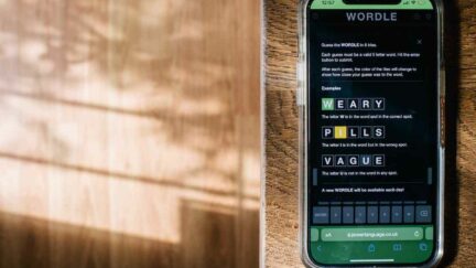 In this photo illustration, the word game Wordle is shown on a mobile phone