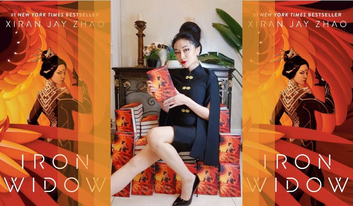 Xiran on their throne flanked by copies of their debut book. (Image: Xiran Jay Zhao and Penguin Teen.)