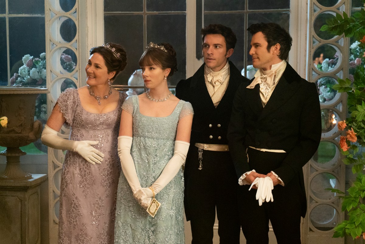 Ruth Gemmell as Lady Violet Bridgerton, Claudia Jessie as Eloise Bridgerton, Jonathan Bailey as Anthony Bridgerton, and Luke Thomspon as Benedict Bridgerton in episode 201 of Bridgerton.
