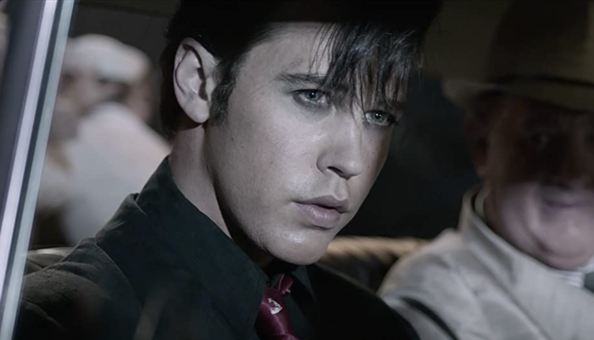 A close up of Austin Butler as Elvis Presley in his car