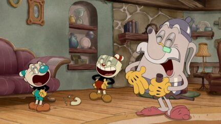 Cuphead, Mugman, and Elder Kettle laugh in their living room.