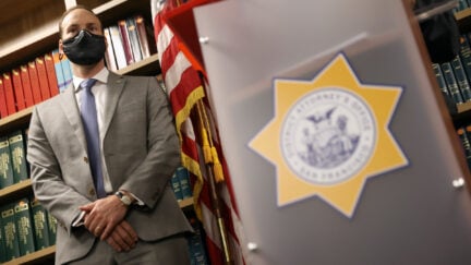 San Francisco District Attorney Chesa Boudin looks on during a press conference at his office