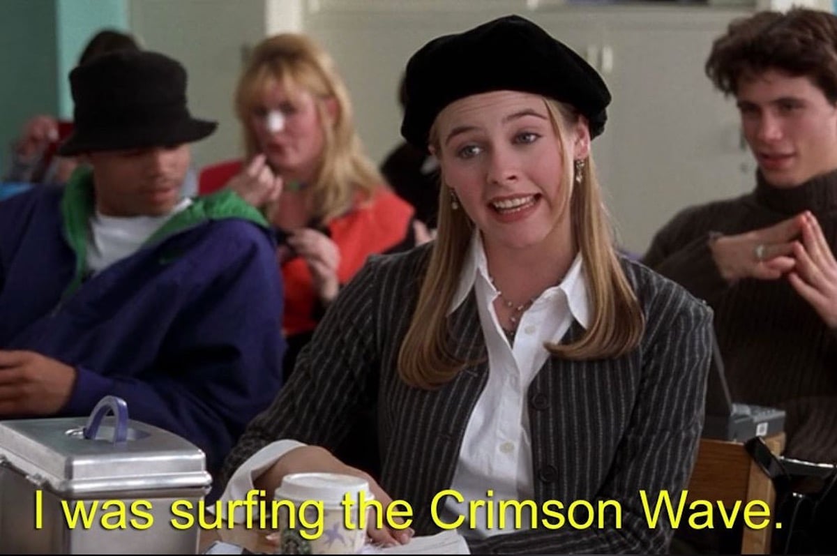 Alicia SIlverstone speaks in a scene from Clueless with a caption reading "I was surfing the crimson wave"