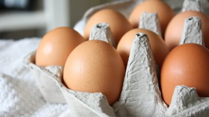 A closeup of brown eggs in a cardboard egg carton