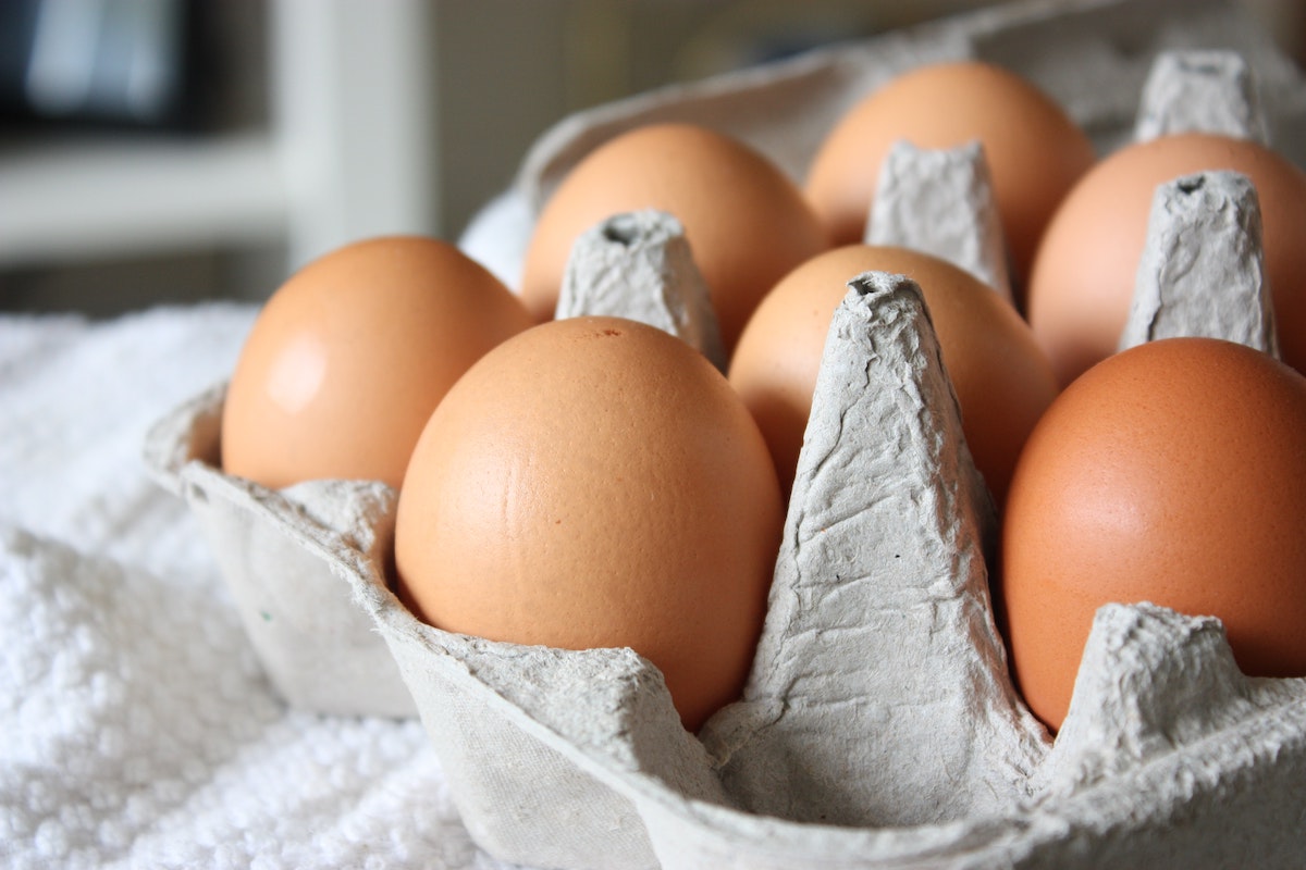A closeup of brown eggs in a cardboard egg carton