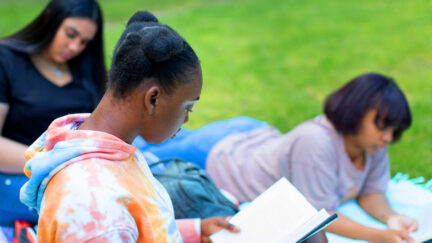Three Black and brown girls reading. (Image: Nappy.co user @childrennaturenetwork.) SOURCE: https://nappy.co/photo/3073/children-and-nature