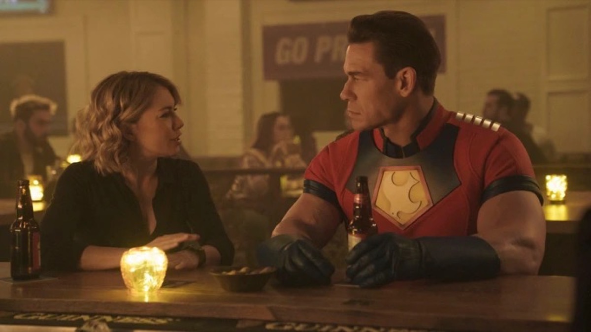 Harcourt and Peacemaker sitting at a bar.