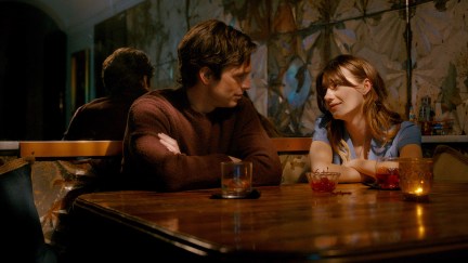 Sebastian Stan and Daisy Edgar-Jones sitting at a table in Fresh