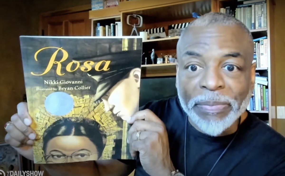 LeVar Burton holding up the book "Rosa" on The Daily Show With Trevor Noah.