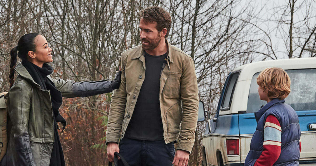 Zoe Saldana grabs Ryan Reynolds arm in the Adam Project