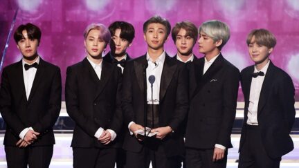 A picture of the seven members of BTS (left to right: J-hope, Jimin, Jungkook, RM, Jin, V and SUGA) presenting an award at the 2019 Grammy Award Ceremony