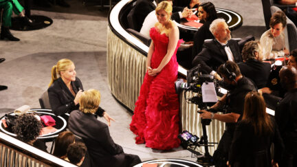 Kirsten Dunst standing off to the side at the Oscars
