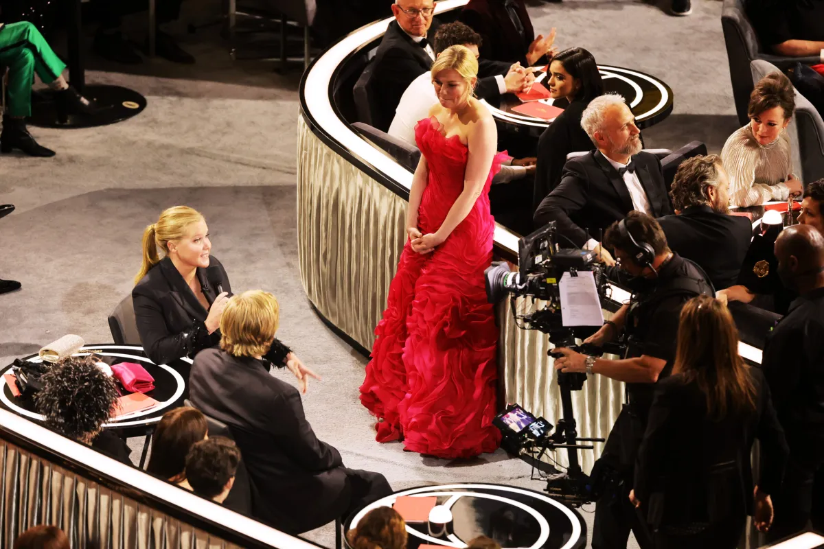 Kirsten Dunst standing off to the side at the Oscars