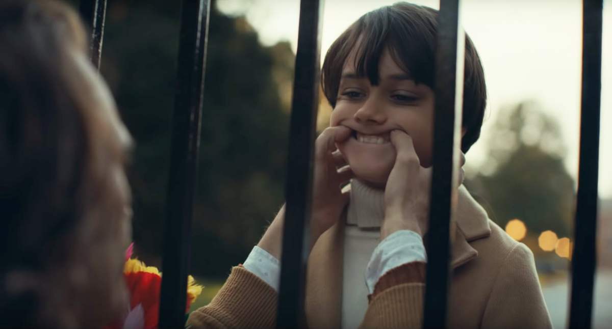 Joaquin Phoenix as the Joker makes Dante Pereria-Olson's Bruce Wayne smile in The Joker