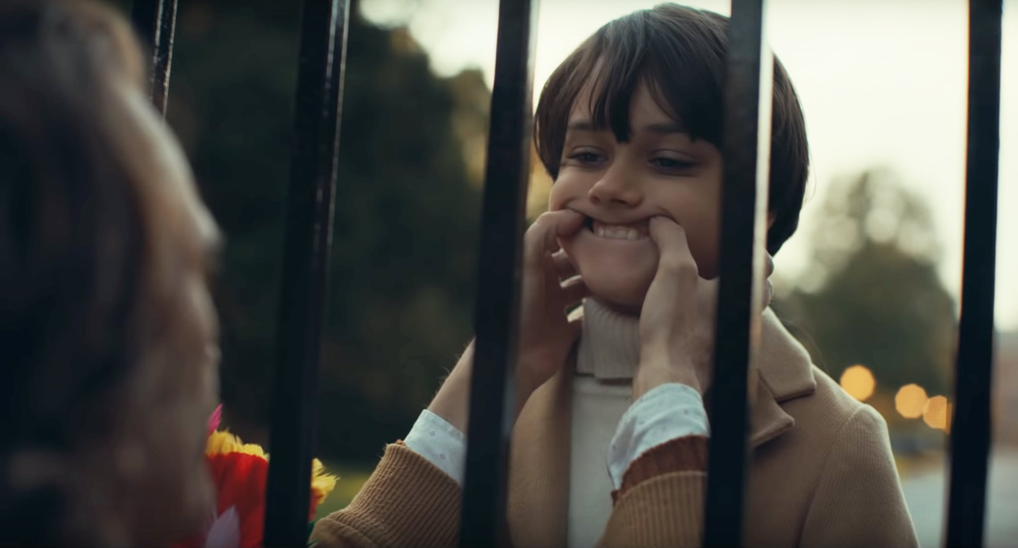 Joaquin Phoenix as the Joker makes Dante Pereria-Olson's Bruce Wayne smile in The Joker