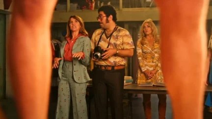 Joyce and Doug look at a male nude model, whose legs are visible.