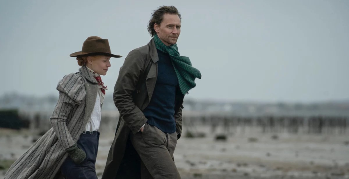 Claire Danes and Tom Hiddleston walk on the beach in the Essex Serpent