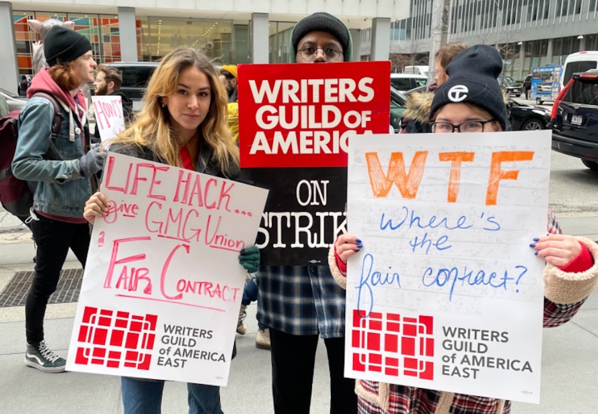 GMG writers hold signs as they strike outside of office