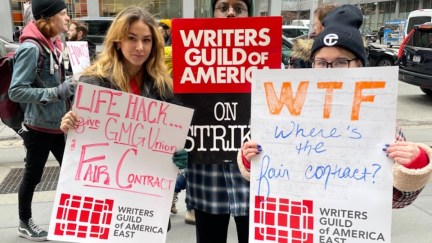 GMG writers hold signs as they strike outside of office