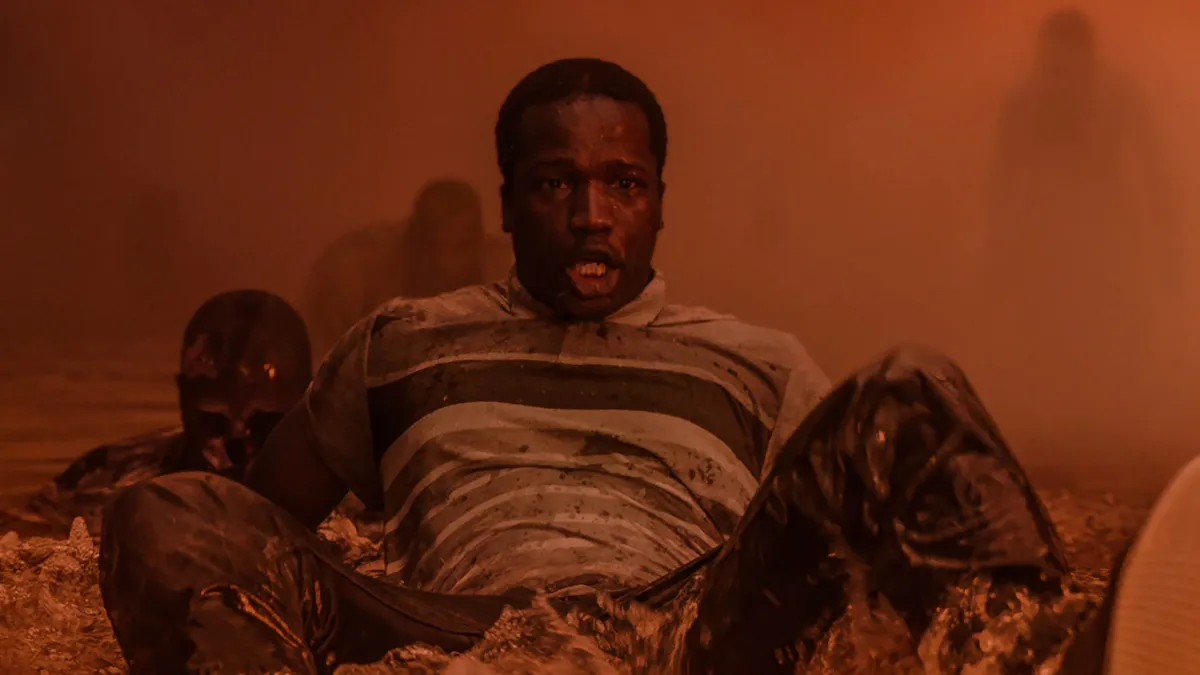 Bol sitting in a pool of water surrounded by ghosts in His House
