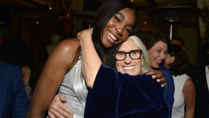 Jane Camion hugs Venus Williams from the side with both arms wrapped around her.