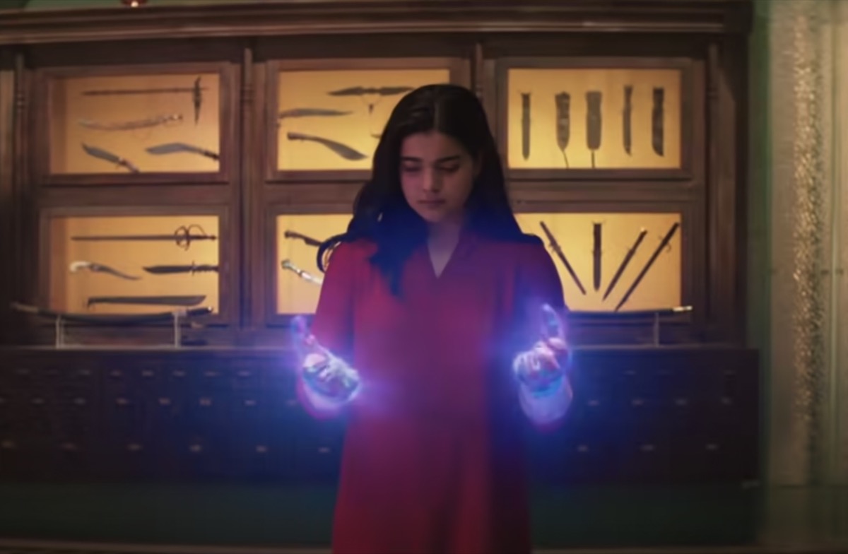 Kamala Khan looks over her glowing hands in Ms. Marvel.