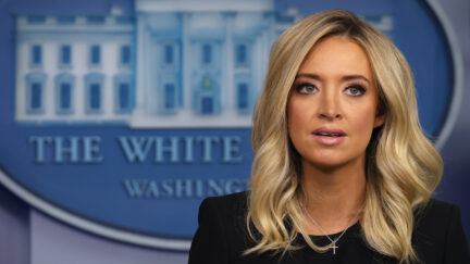 Kayleigh McEnany speaks in front of the White House logo during a press briefing.