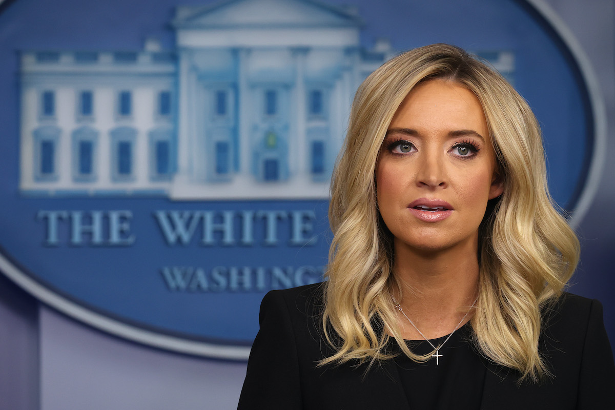 Kayleigh McEnany speaks in front of the White House logo during a press briefing.