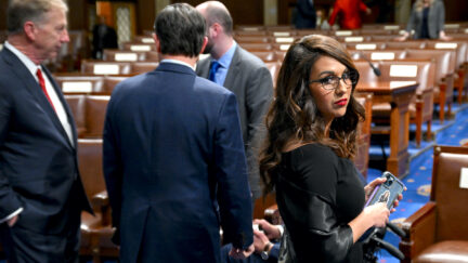Lauren Boebert stands alone before the State of the Union, looking at the camera and looking sad