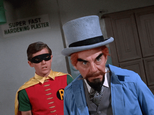 1960s Batman deflecting the hypnotism rays from the Mad Hatter's hat.