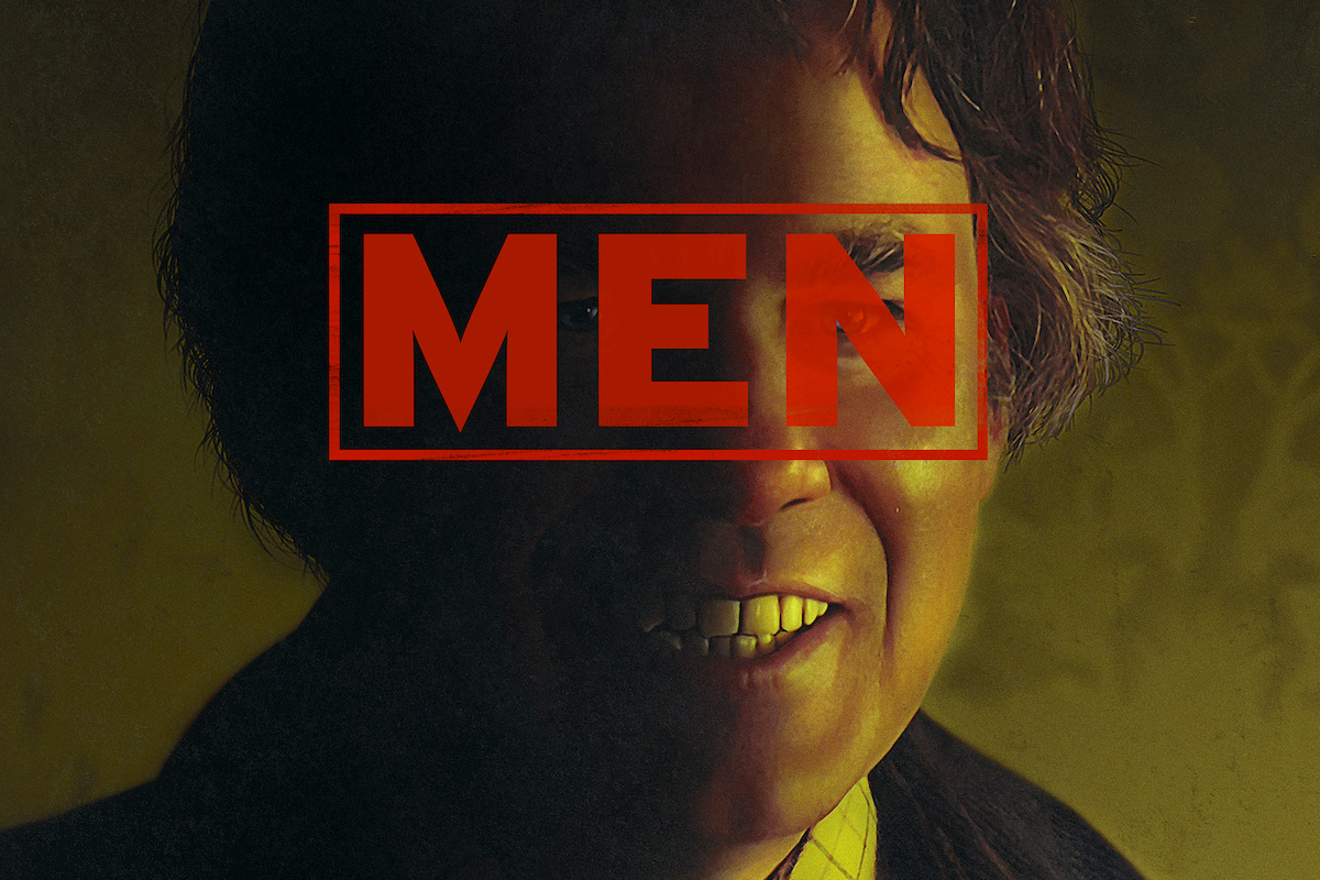 A white man's face, smiling, with a rubber stamp image of the word "MEN" over his face