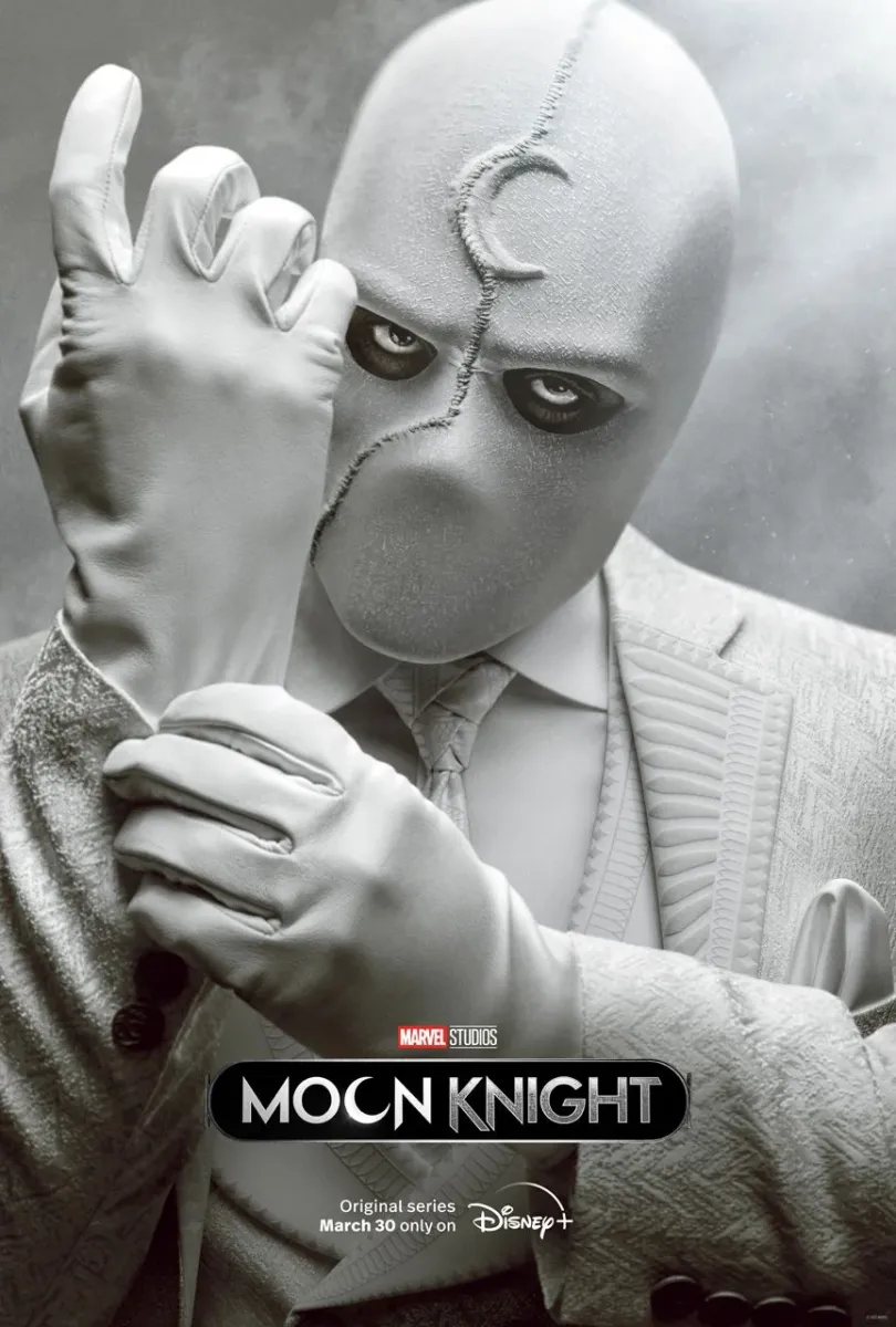 Mr Knight in his all white suit adjusting his white gloves in a new poster for Moon Knight