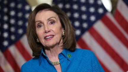 Speaker Nancy Pelosi wears a shamrock pin