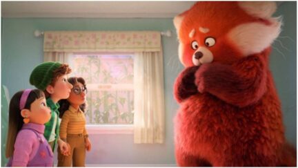 Mei, nervous, in Red Panda form in Pixar's Turning Red, as her friends look on.